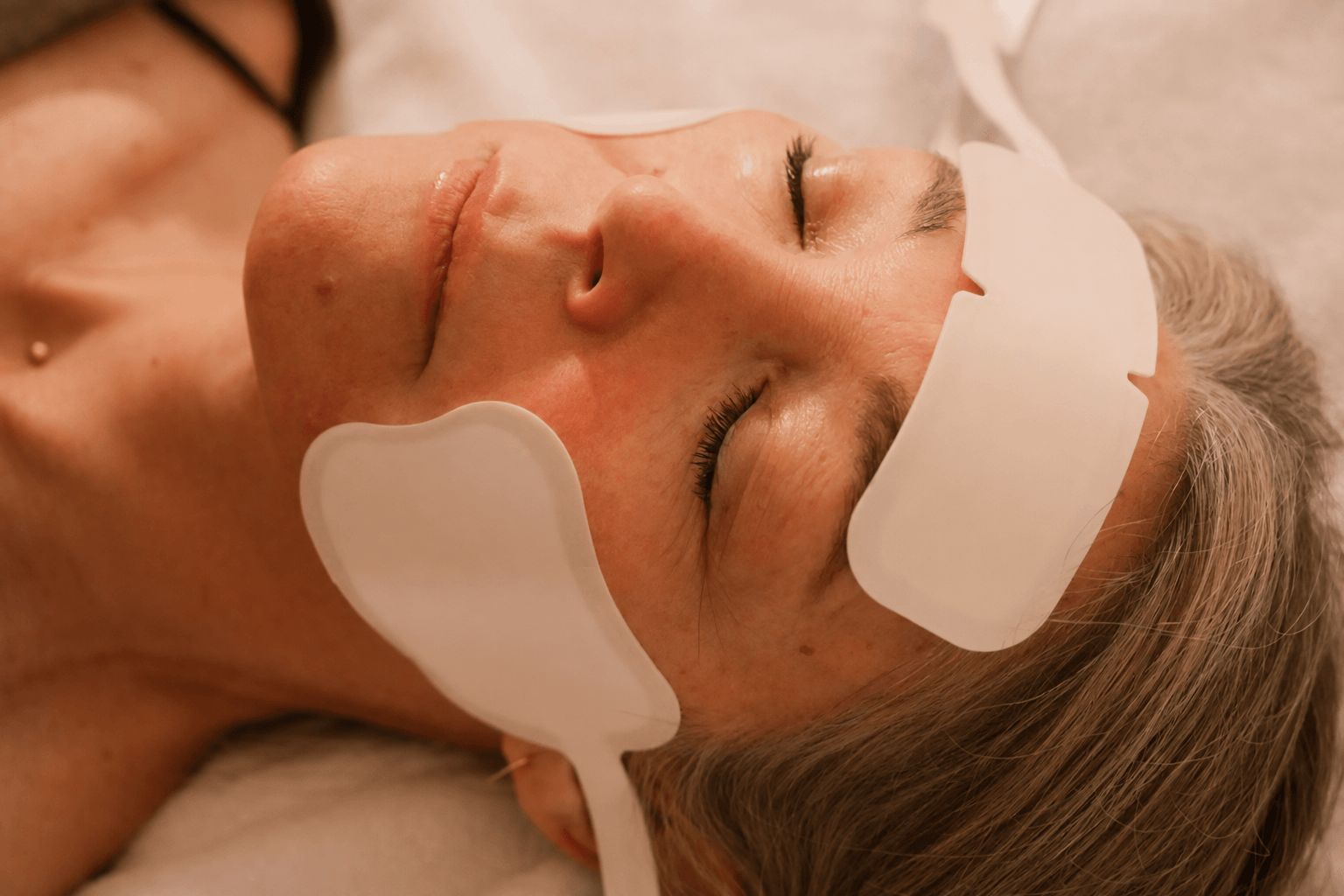 Client receiving WORTHY Face NMS neuromuscular stimulation and radiofrequency facial treatment at WORTHY Self-Care Studio in Berkeley
